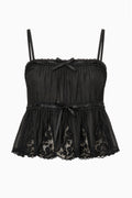 Black lace camisole top with thin straps and gathered tiered design