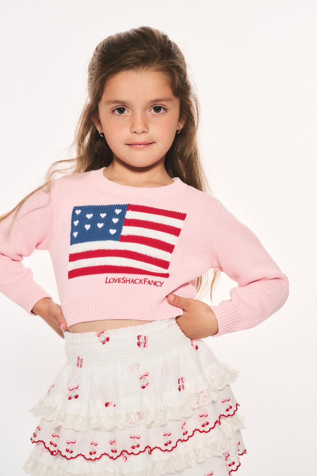Girls' pink knit flag pullover, front flag patch with small chest logo