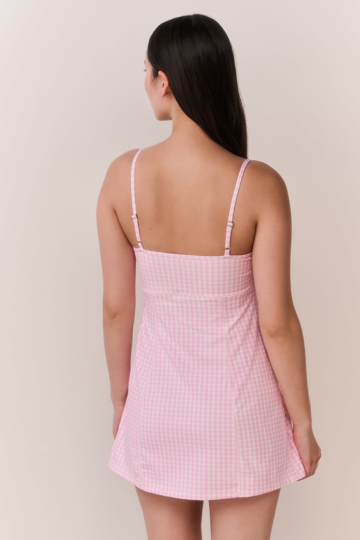 Back view of pink gingham active dress with adjustable spaghetti straps