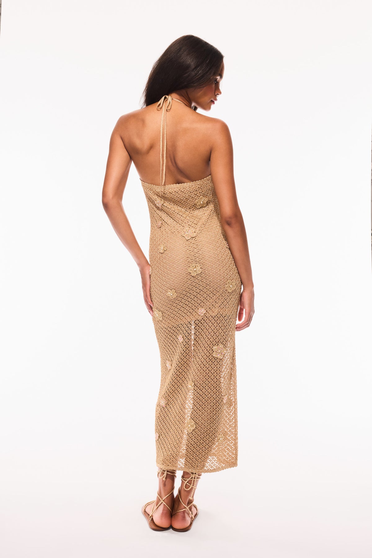 Back view of metallic crochet halter dress, open back and midi column fit