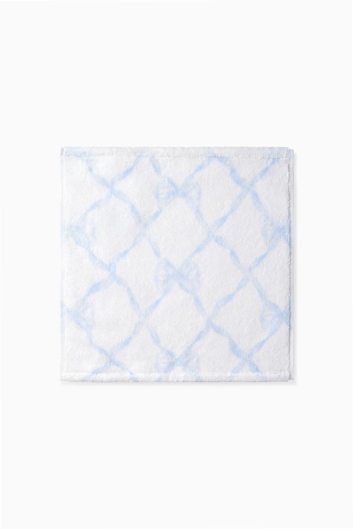 Blue printed wash cloth with a geometric lattice pattern