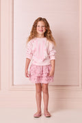 Light pink sweatshirt with long sleeves and butterfly graphic print at the front