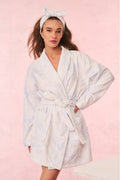 White floral cotton bath robe with tie waist and shawl collar, long sleeves.