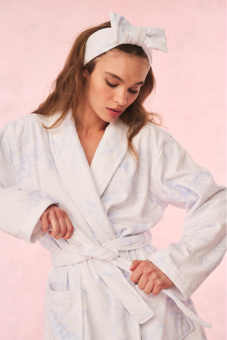 Light blue floral cotton bath robe with tie belt and shawl collar, sleeves rolled.