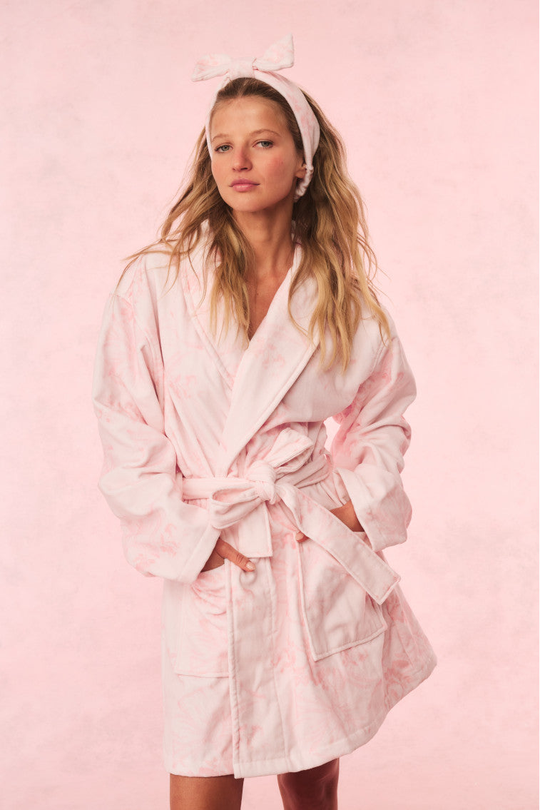 Light pink floral cotton bath robe with tie belt, shawl collar, and long sleeves.