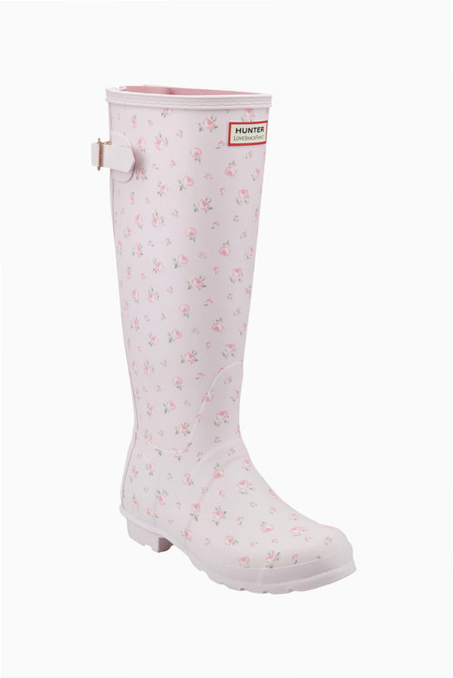 White tall rain boots with small pink floral print, Hunter logo patch and side strap