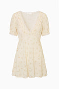 Floral mini dress front, lace V-neck and puff sleeves, light cream with scattered blossoms