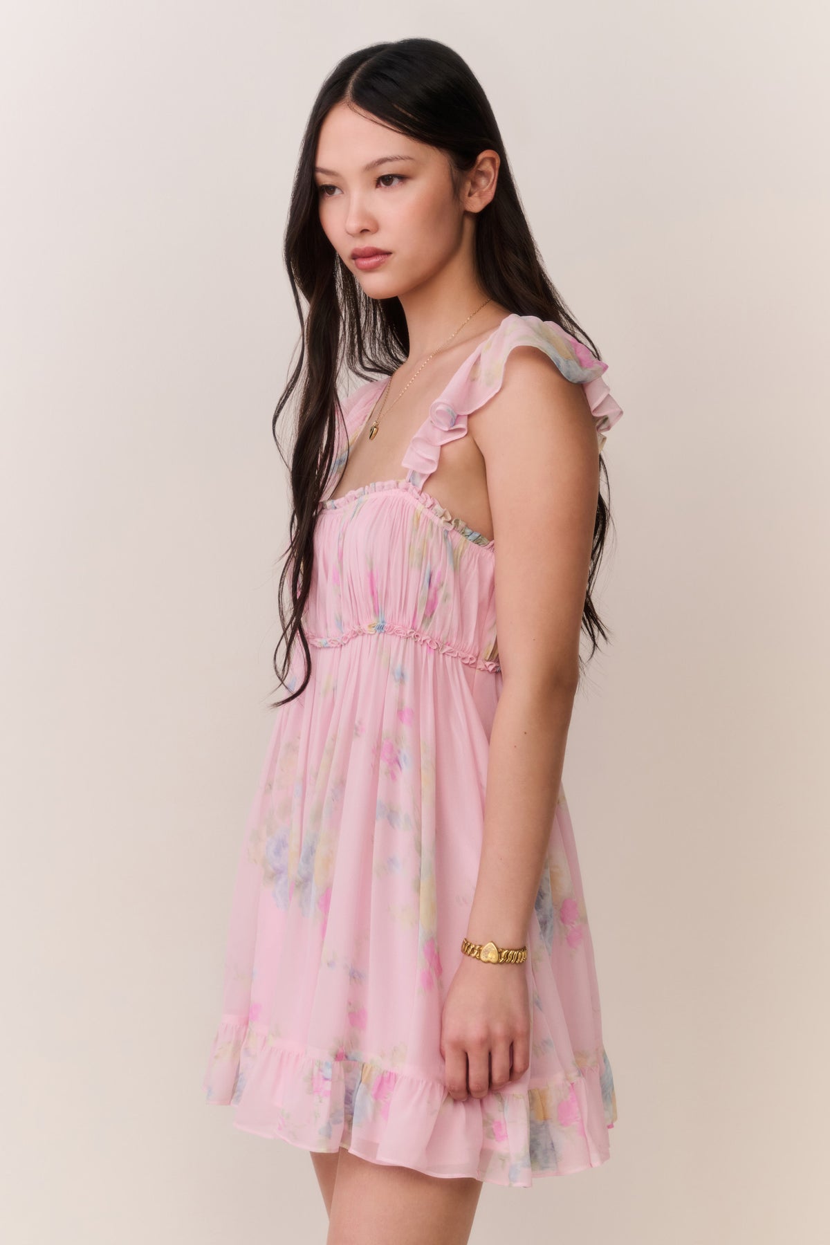 Pink floral chiffon mini dress with off-shoulder neckline and flutter sleeves, tiered skirt