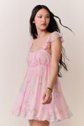 Pink floral chiffon mini dress with smocked bodice, ruffled straps, and layered skirt