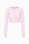 Front view of mauve-pink zip jacket with allover bow pattern, long sleeves