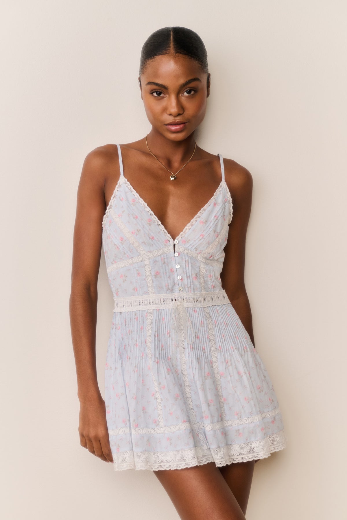 Floral cotton mini dress with V-neck lace trim, button front, and tiered skirt