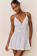 Floral cotton mini dress with spaghetti straps, lace hem, and gathered waist