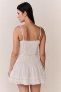 White cotton Victorian mini dress with spaghetti straps, lace trim, tiered skirt