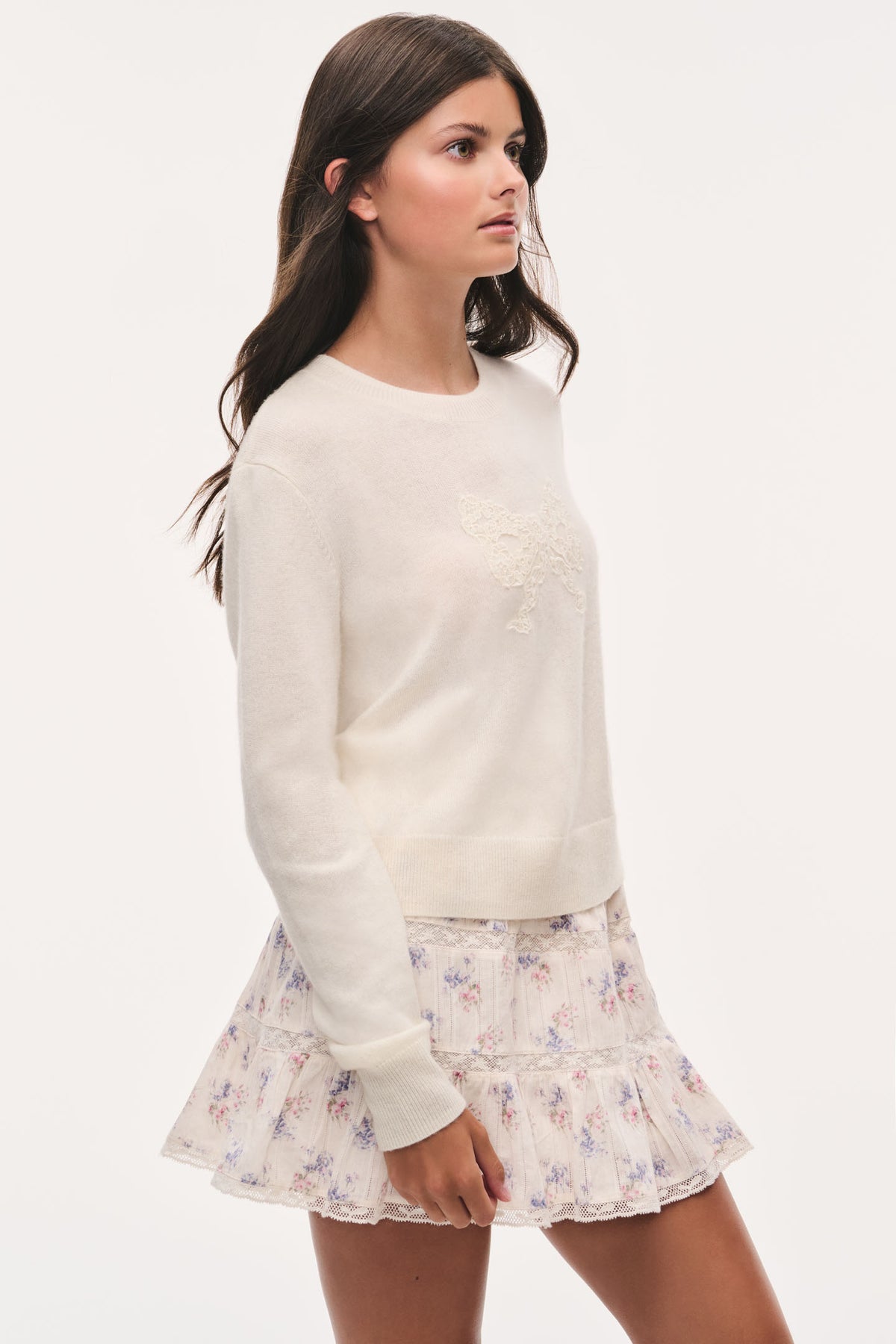 Ivory crewneck pullover sweater with lace bow applique and long sleeves