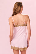 Light pink slip dress back view with lace trim on straps and scalloped hem