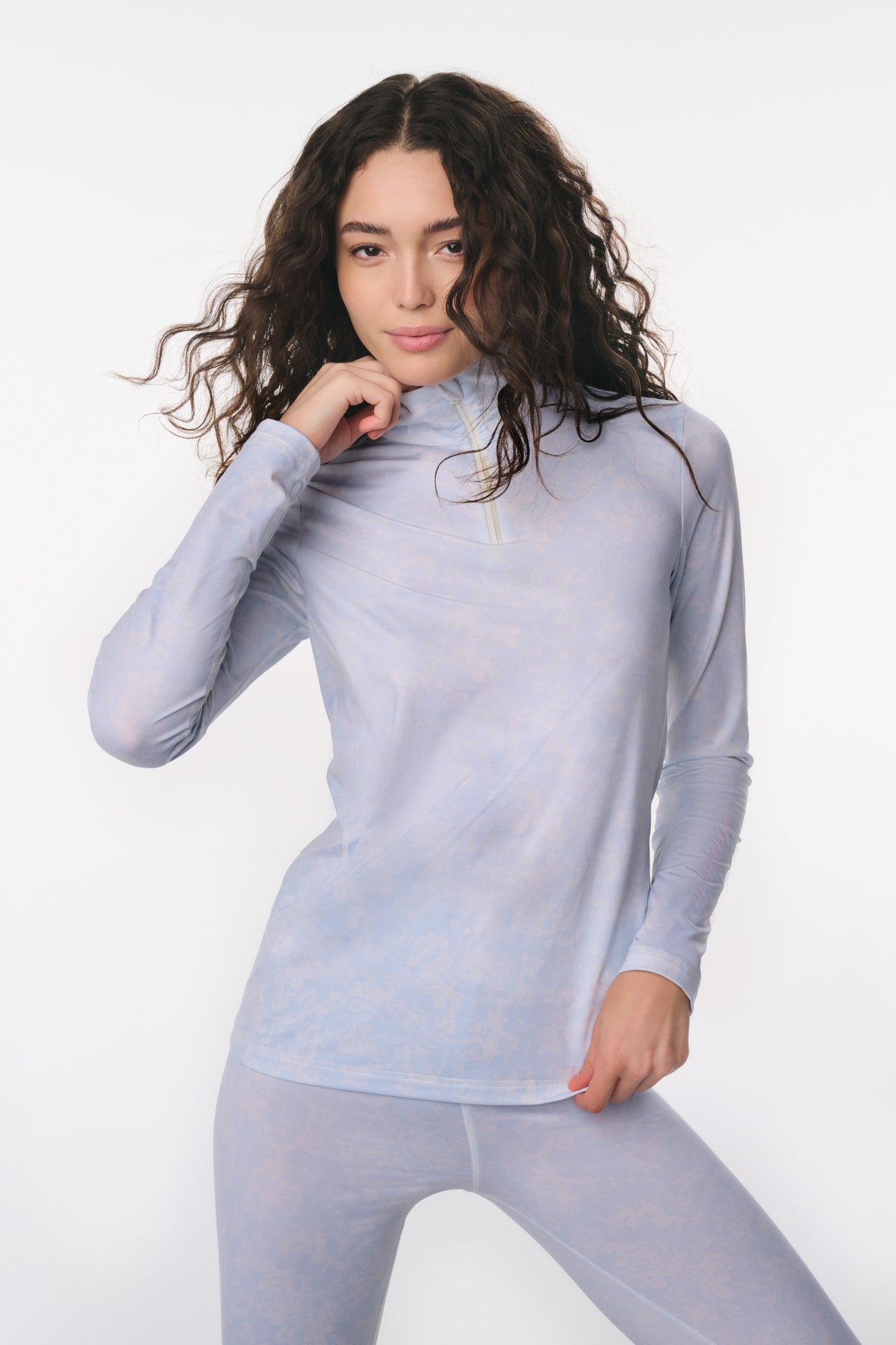 Women’s light blue half-zip pullover with subtle allover pattern and long sleeves