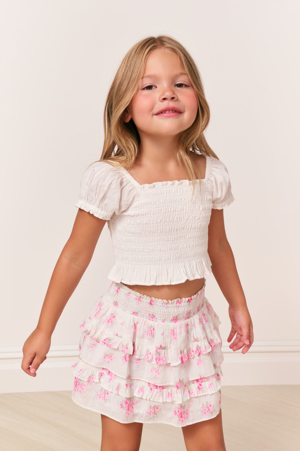 Girls cotton top in antique white with puff sleeves and smocked front.