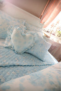 Ruffle heart pillow with light blue floral print and puffed ruffle trim