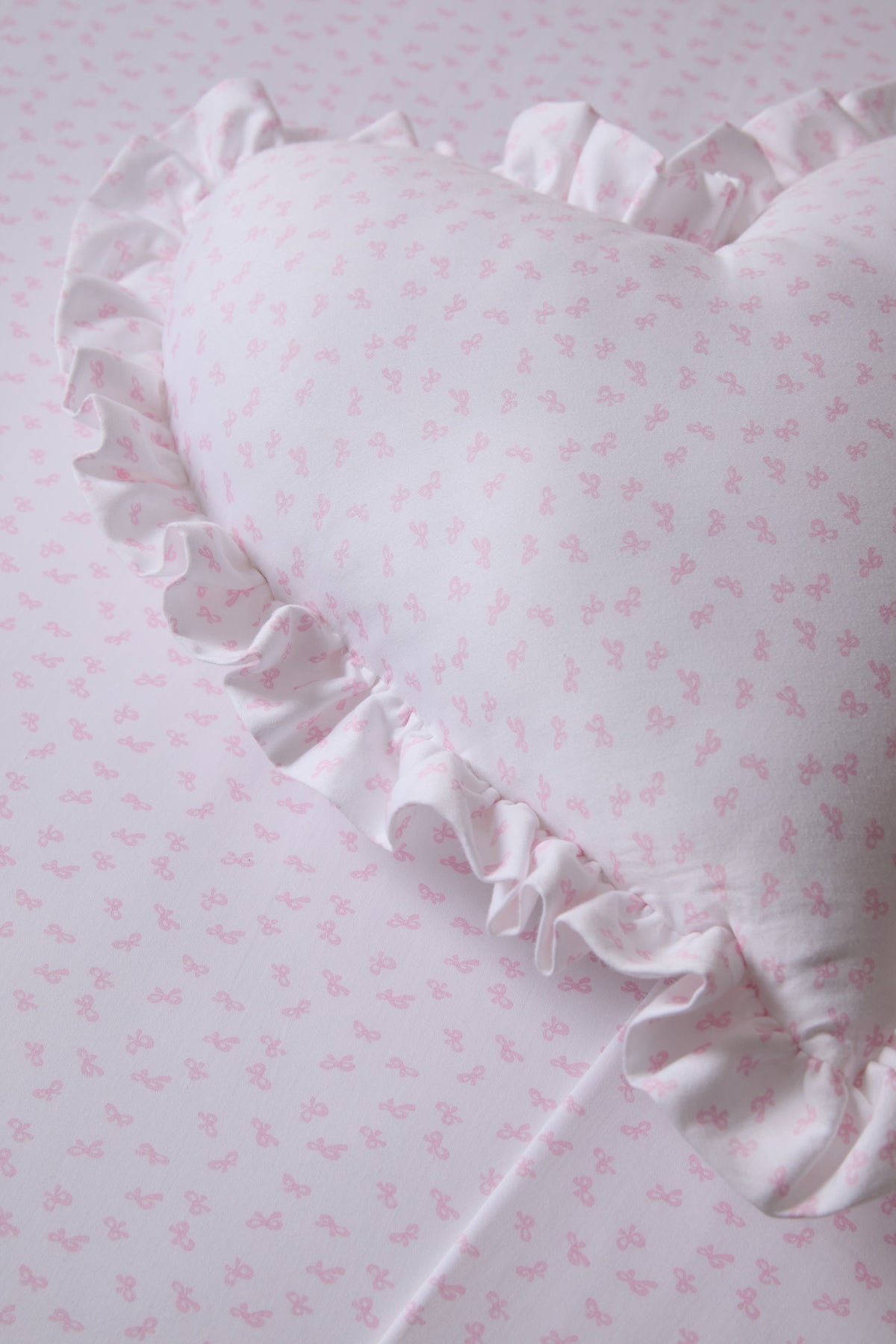 Light pink printed cotton pillow sham with ruffled edge detail