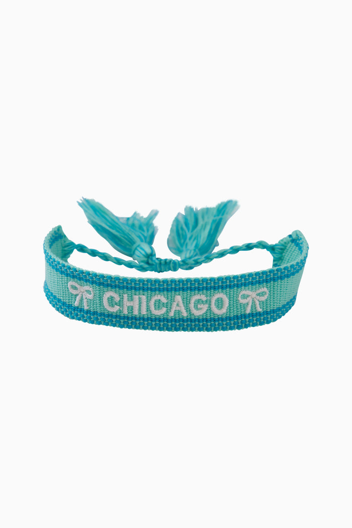 Turquoise woven bracelet with fringed ends and 'Chicago' lettering