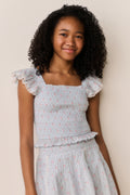 Floral cotton top with square neckline, ruffled sleeve edges, and textured waist gathers