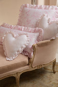 Pink ruffle throw pillow with textured dotted fabric and frilled edges