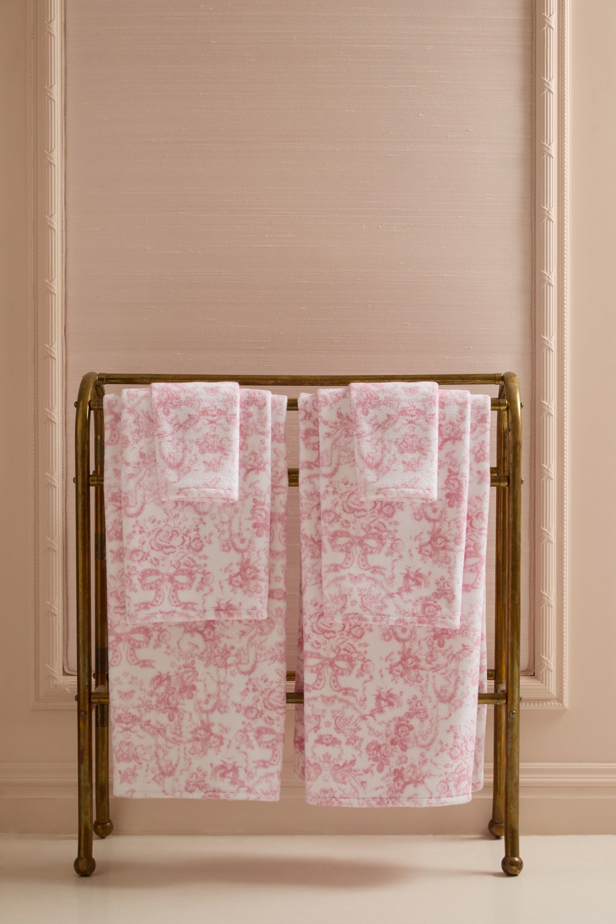 Cotton bath towel set, pink floral bow pattern, neatly folded pair.