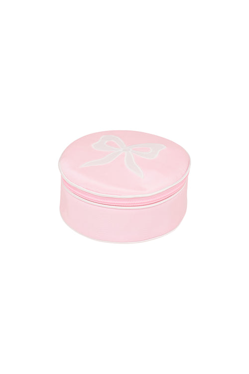 Round zip jewelry case in dusty rose pink, top view with bow outline on lid