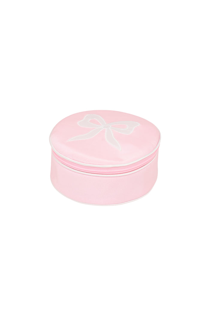 Round zip jewelry case in dusty rose pink, top view with bow outline on lid