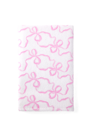 Pink cotton hand towel with bow-like pattern, close-up