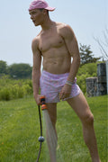 Lilac floral swim shorts with elastic waistband and drawstring ties.