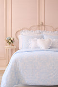 Light blue floral duvet cover and sham set with ruffle trim and decorative pillows