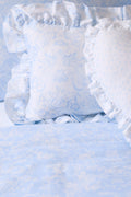 Light blue floral duvet cover and sham set close-up with ruffled edges