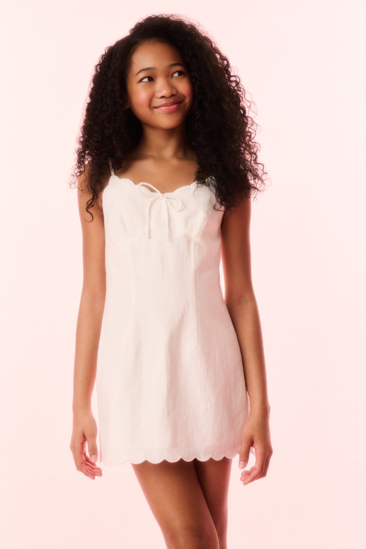 Girls off-white linen mini dress with tie straps and scalloped hem