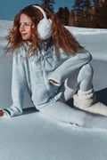 Girl in winter clothing wearing off-white faux-fur boots with visible cuff detail