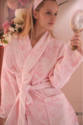 Light pink floral cotton bath robe with tie belt and shawl collar, long sleeves.