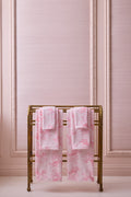 Cotton bath towel set, pink patterned towels folded and displayed on rack
