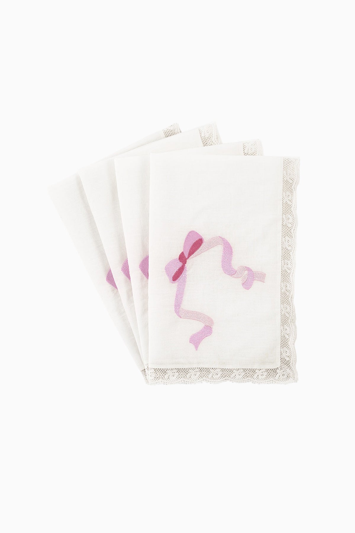 Stack of white embroidered napkins with pink silhouette motif and lace edge
