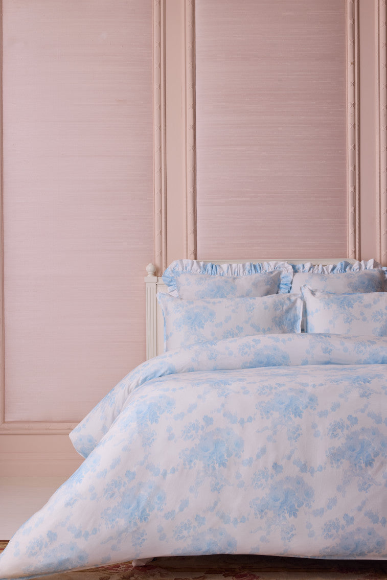 Light blue printed duvet cover set with ruffled shams featuring small floral pattern