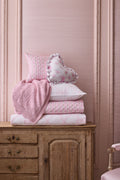Pink pointelle throw blanket stack with embroidered heart knit