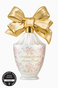 Eau de parfum bottle with gold bow, pink floral label, and award seal badge