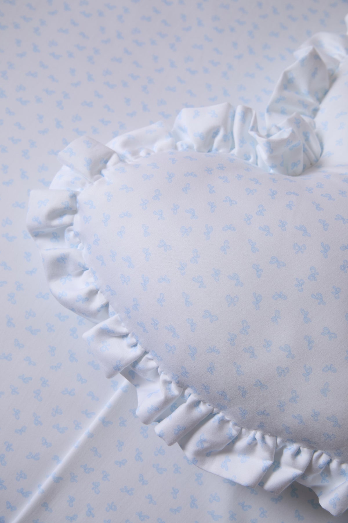 Light blue printed cotton pillow sham with ruffled edge detail