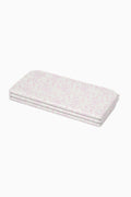 Folded light pink floral yoga mat with layered edges