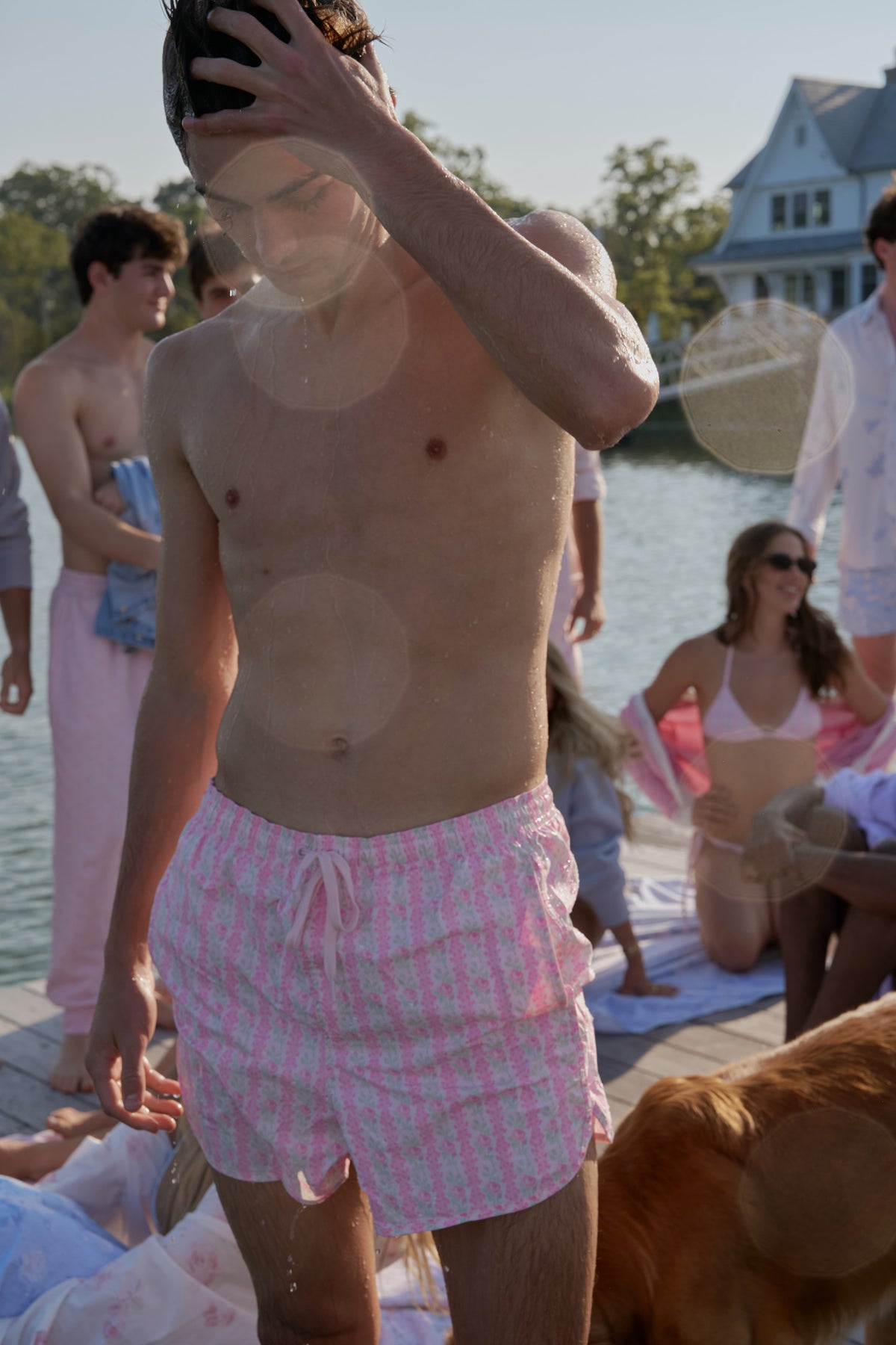Pink printed swim shorts with elastic waistband and drawstring tie