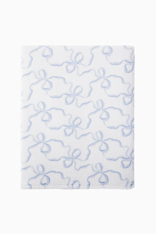 Cotton bath towel, light blue floral bow pattern, flat folded view.