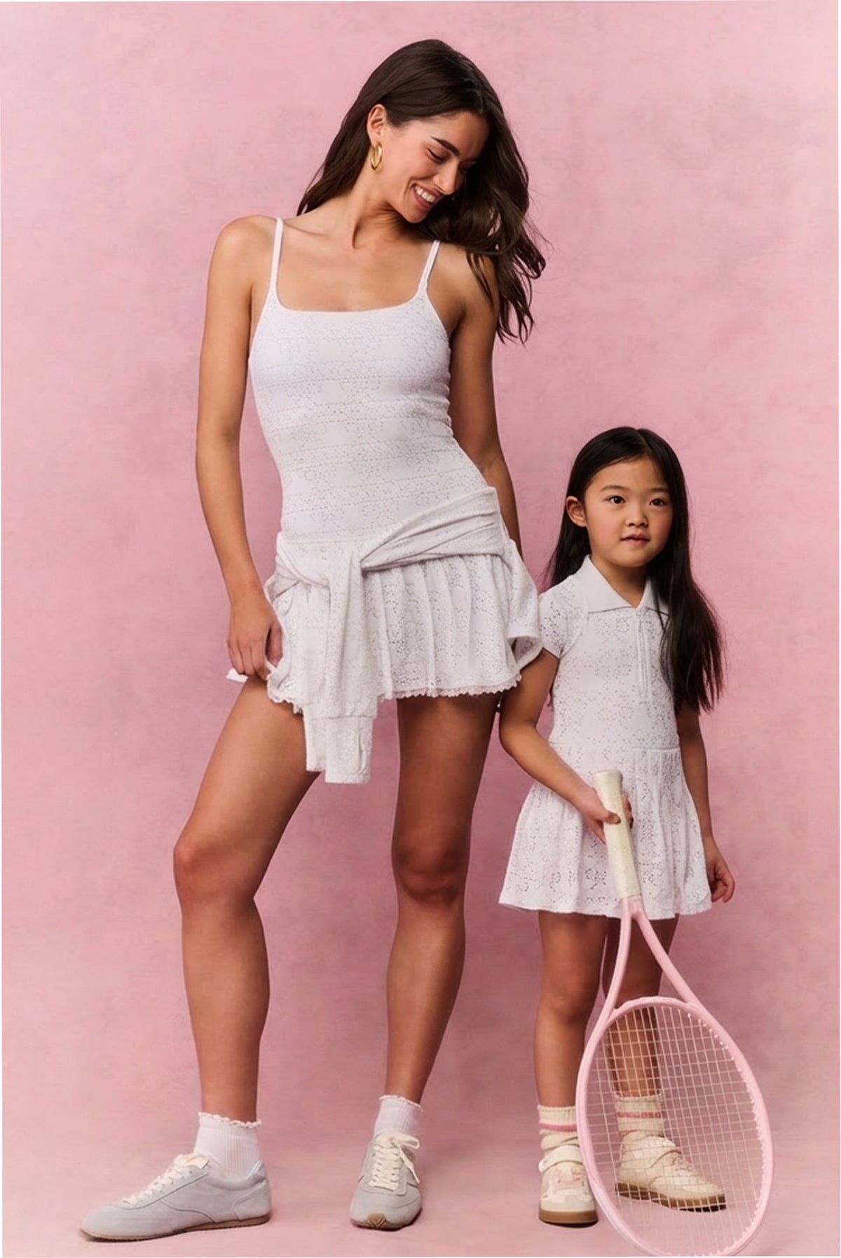 Matching true white eyelet mini dresses with spaghetti straps and tiered skirts
