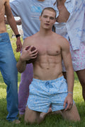 Light blue printed swim shorts with drawstring waist, gathered at the sides