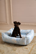 Light blue printed dog bed with padded edges and open center