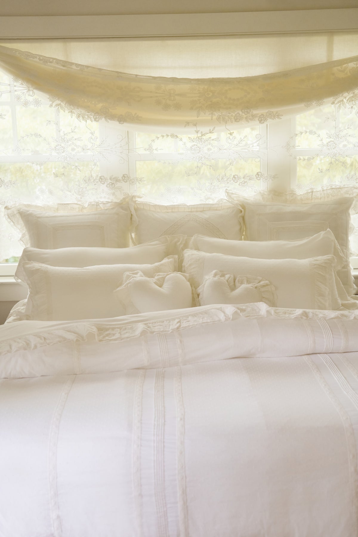 White Victorian duvet and shams with ornate ruffles and soft bedding layers