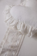 White pillowcase with eyelet trim, lace ruffle, and gathered fabric border